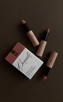 Three lip tints and a Beauté box labeled GUAVA PALOMA COCOA, SMOOTHING LIP TINTS, LUX UNFILTERED