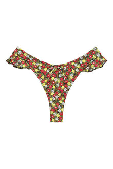 Bikini bottom with red, yellow, and white floral print on dark background, featuring ruffled side details.