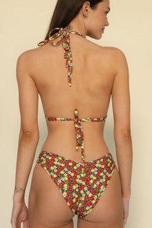 Red, yellow, and white floral print bikini bottom with halter tie straps, shown from back view.