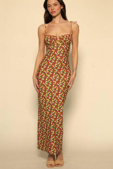 Long slip dress with red, yellow, and white floral print, sweetheart neckline, and thin adjustable straps.