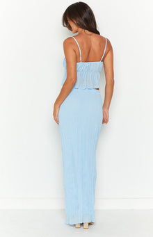 Close-up showing the light blue crinkled texture of the maxi skirt and the ruffled elastic waistband