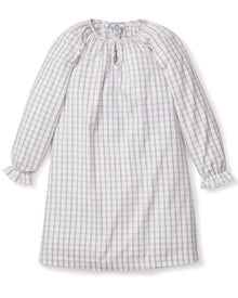 The Girls Twill Delphine Nightgown in Regent Tattersall by Petite Plume is a knee-length, long-sleeved dress with a gray and white checkered pattern. Made from yarn-dyed cotton, it has a round neckline with a keyhole opening and ruffled cuffs. The soft, lightweight fabric is ideal for casual wear.