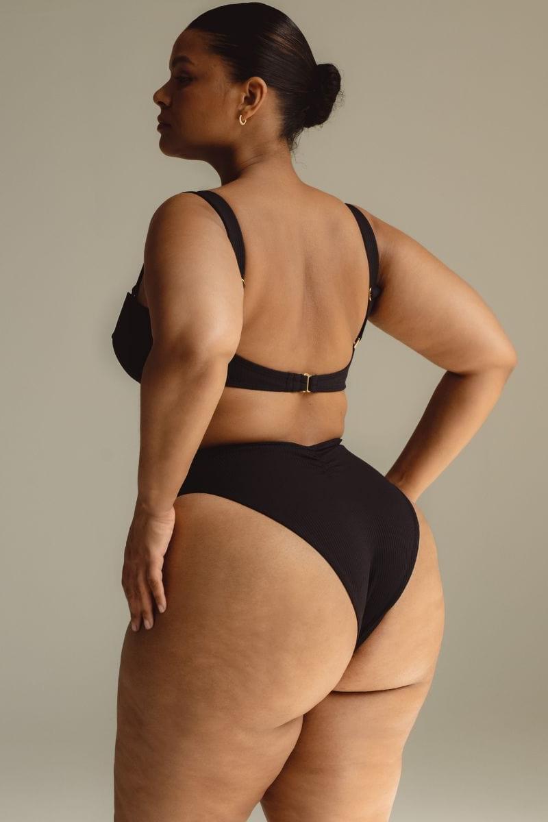 Black ribbed bustier bikini top with adjustable straps and back clasp closure.