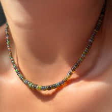 Labradorite grey opal necklace on the neck with sunlight.
