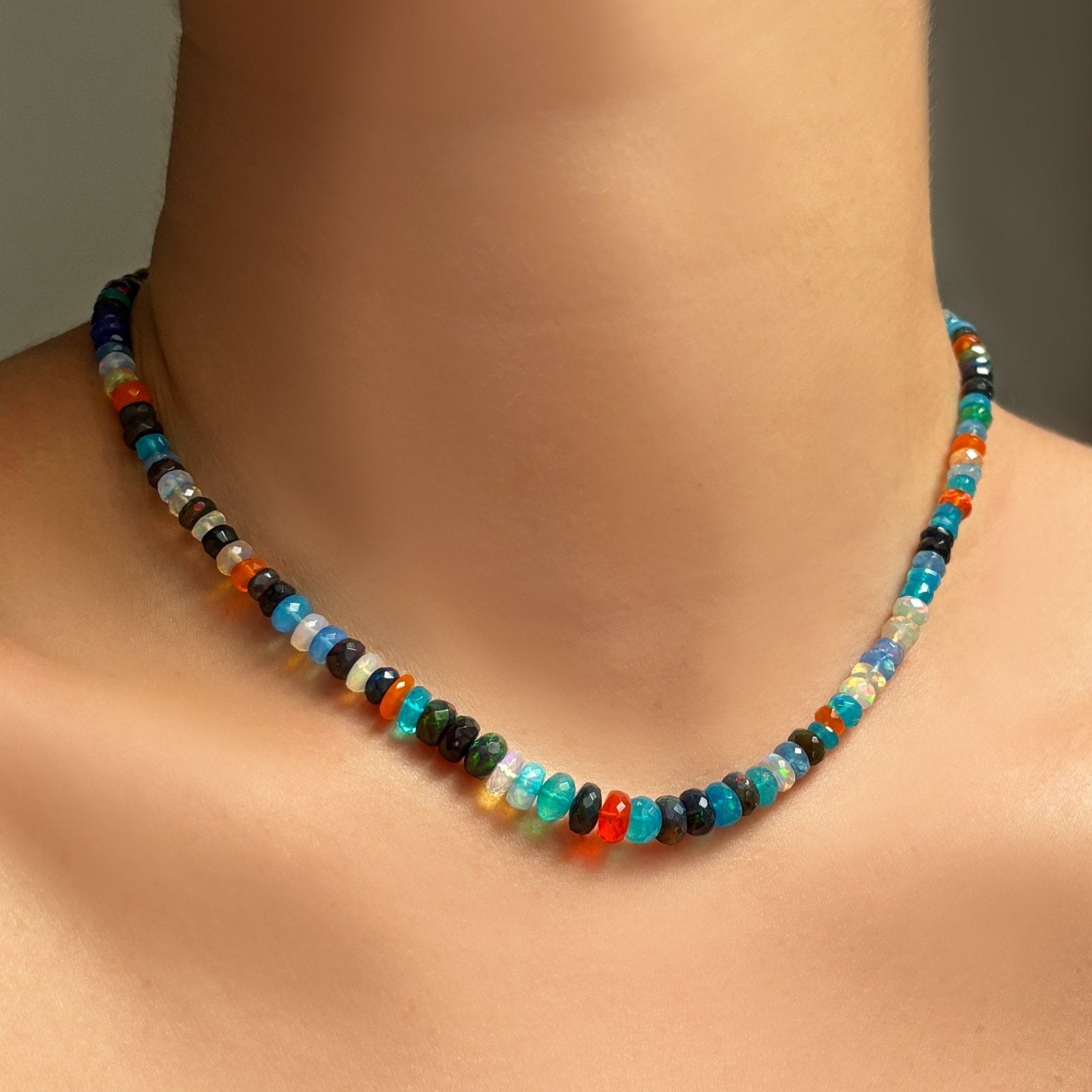 A model wears a Jaipur Jazz faceted opal necklace around her neck.