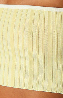 Mid-shot of a yellow ribbed knit tube top featuring white contrast binding on the strapless neckline and hem