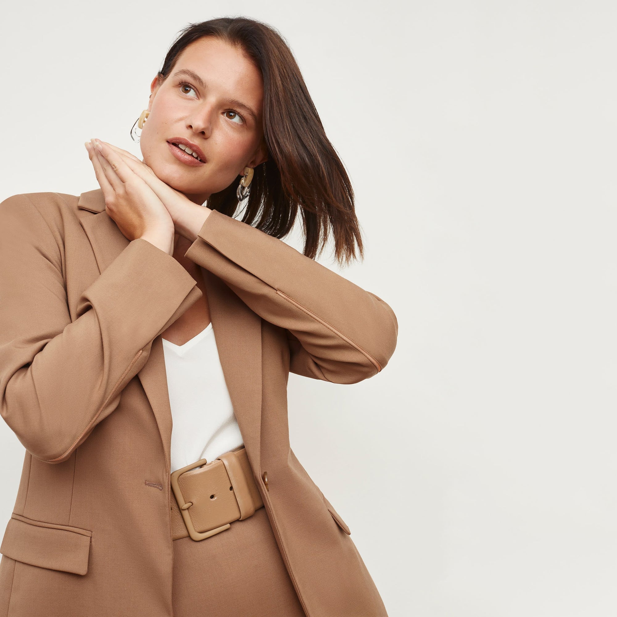 Front image of a woman standing wearing the Yiyan Blazer in Camel | Exclude
