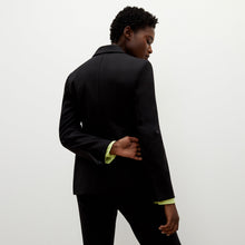 Back image of a woman standing wearing the bennett blazer wool twill in black | Exclude