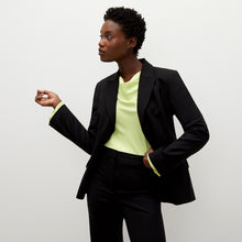 Front image of a woman standing wearing the bennett blazer wool twill in black | Exclude