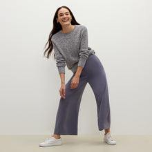 Front image of a woman standing wearing the butler top knit boucle in navy