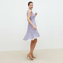 Side image of a woman standing wearing the lindsay dress in cotton boucle  in lapis / ivory