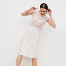 Front image of a woman standing wearing the lenox skirt in twill stripe in ivory / red | Exclude