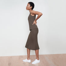 Side image of a woman standing wearing the avery top in safari | Exclude
