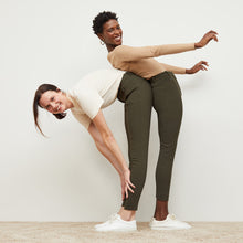 Front image of a woman standing wearing the curie pant in dark olive | Exclude