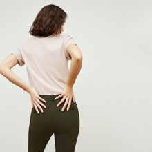Back image of a woman standing wearing the curie pant in dark olive