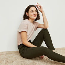 Side image of a woman standing wearing the curie pant in dark olive | Exclude