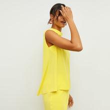 Side image of a woman standing wearing the Daisy Top—Washable Silk in Sunshine