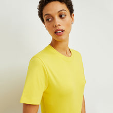 Side image of a woman standing wearing the Leslie T-Shirt—Compact Cotton in Sunshine