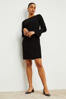 Front image of a woman standing wearing the Regina Dress in Black | Exclude