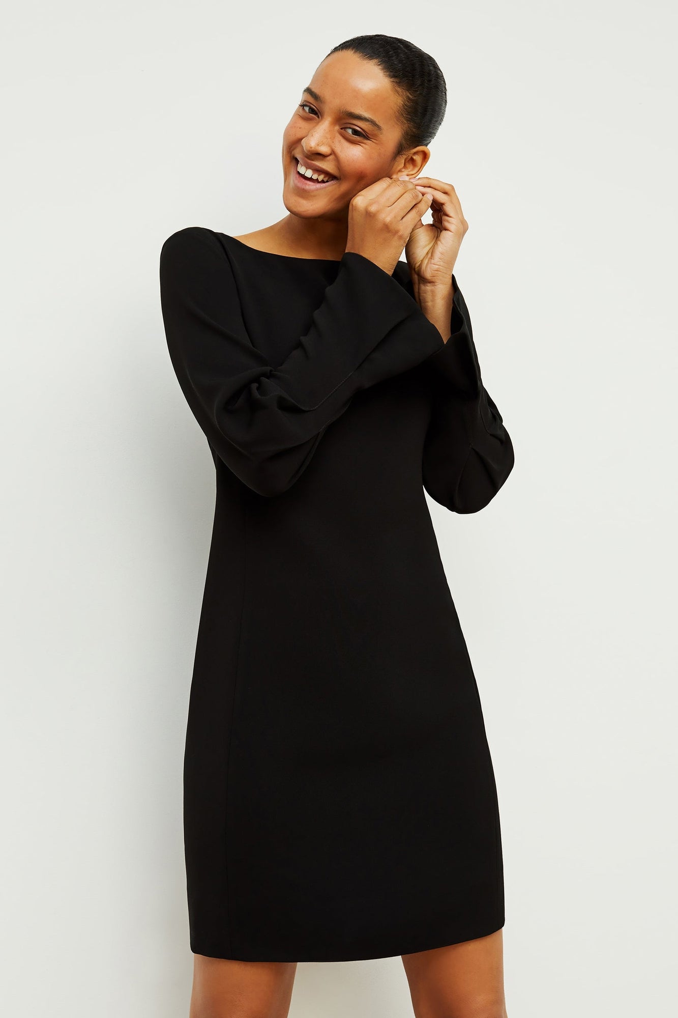 Front image of a woman standing wearing the Regina Dress in Black | Grid | Exclude