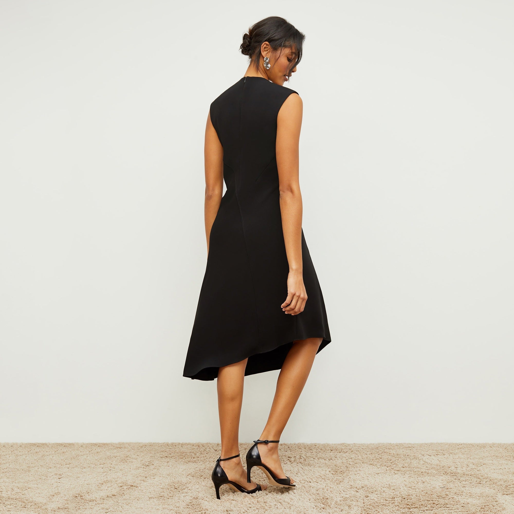 Back image of a woman standing wearing the Lara Dress in Black