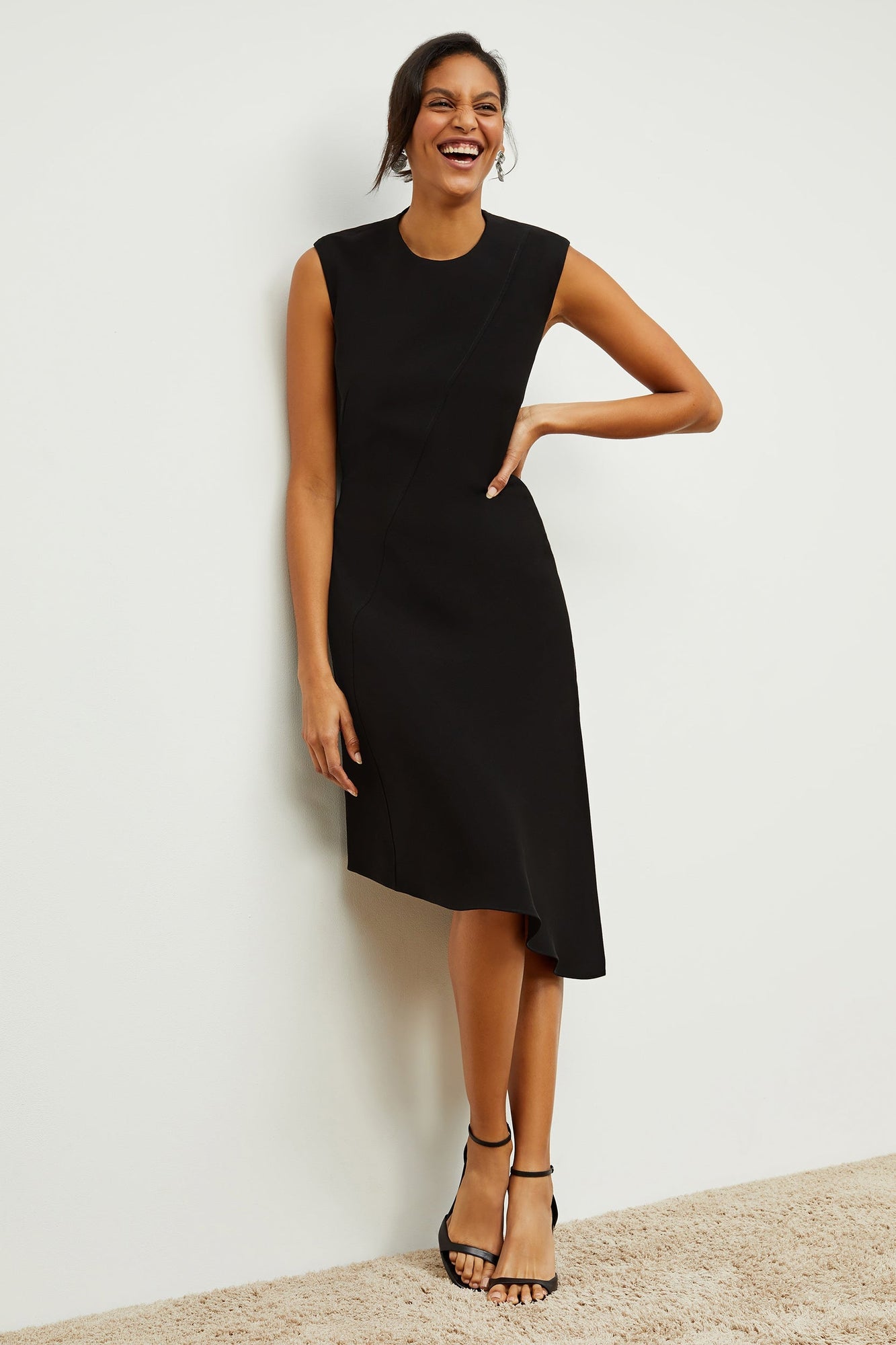 Front image of a woman standing wearing the Lara Dress in Black | Grid | Exclude