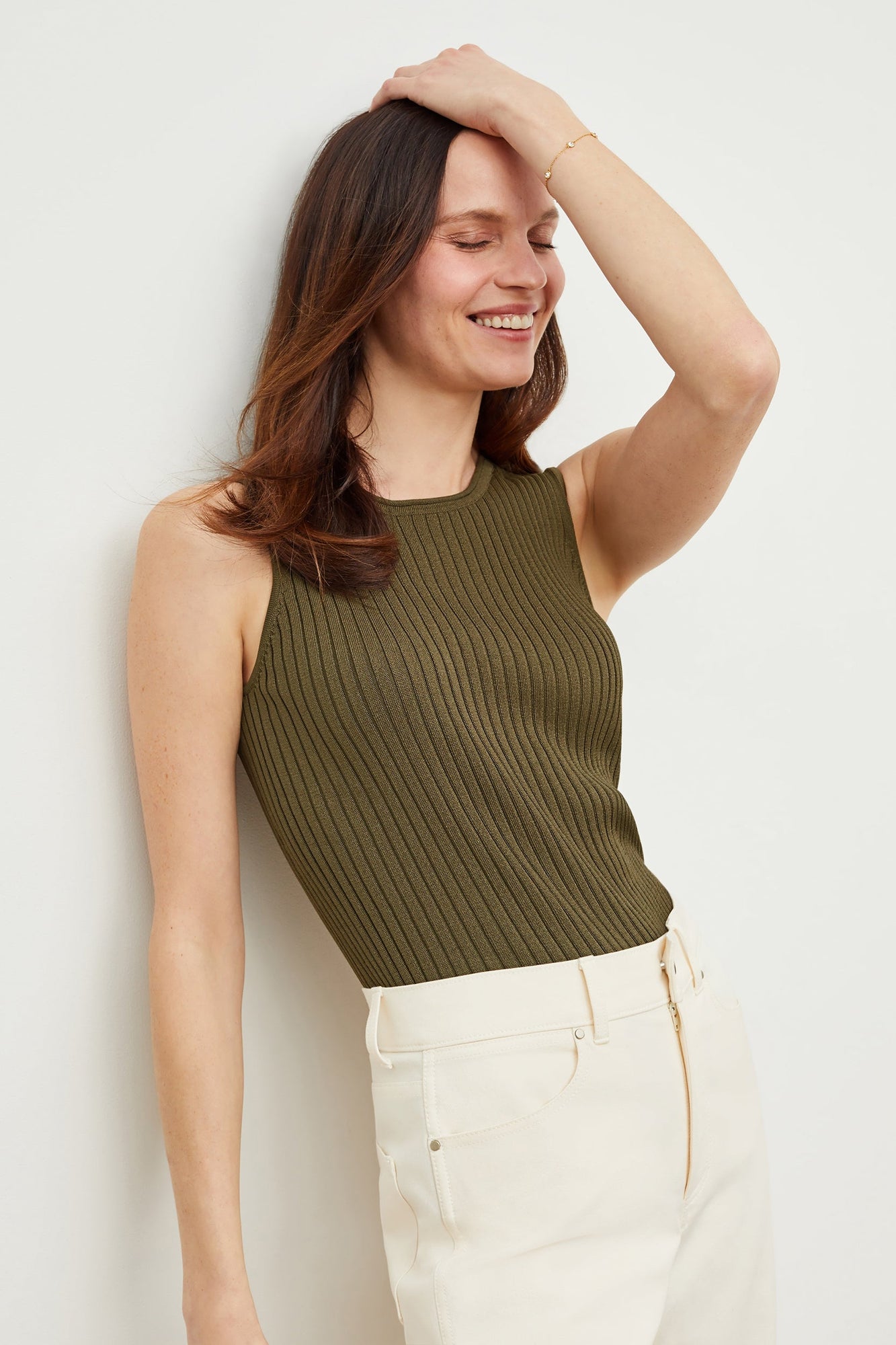 Side image of a woman standing wearing the avery top in safari | Grid | Exclude