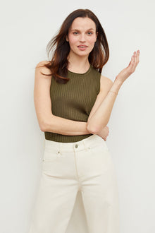Front image of a woman standing wearing the avery top in safari | Grid Hover | Exclude