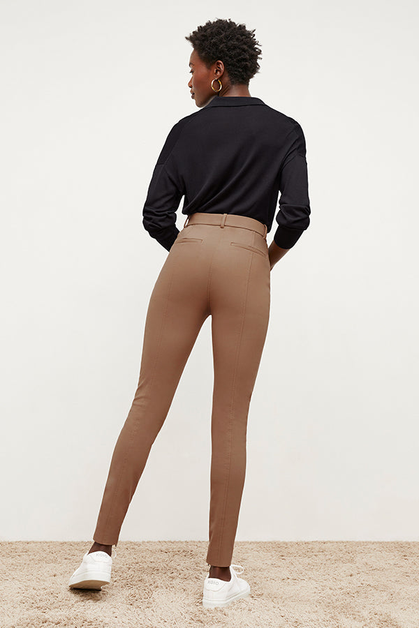 Back image of a woman standing wearing the Curie Pant—Everstretch in Saddle | Exclude