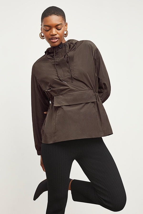 Front image of a woman standing wearing the Britt Hoodie—AirTech in Dark Moss | Grid | Exclude