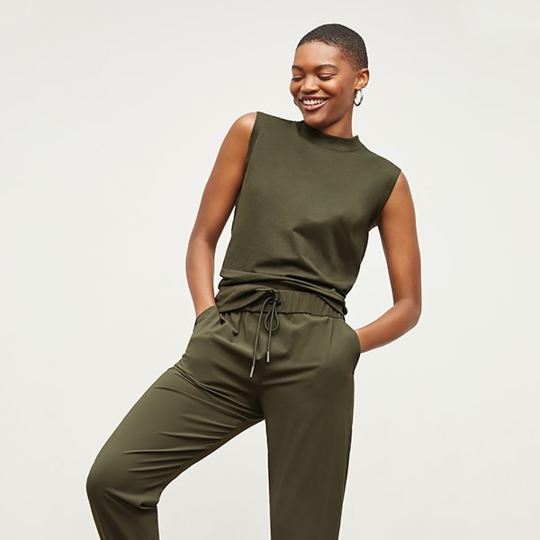 Front image of a woman standing wearing the Delaney Jogger—OrigamiTech in Olive | Exclude