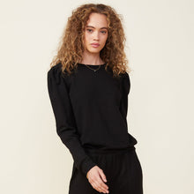 Front view of model wearing the supersoft fleece open back sweatshirt in black.