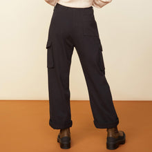 Back view of model in the utility wide leg pants in black.