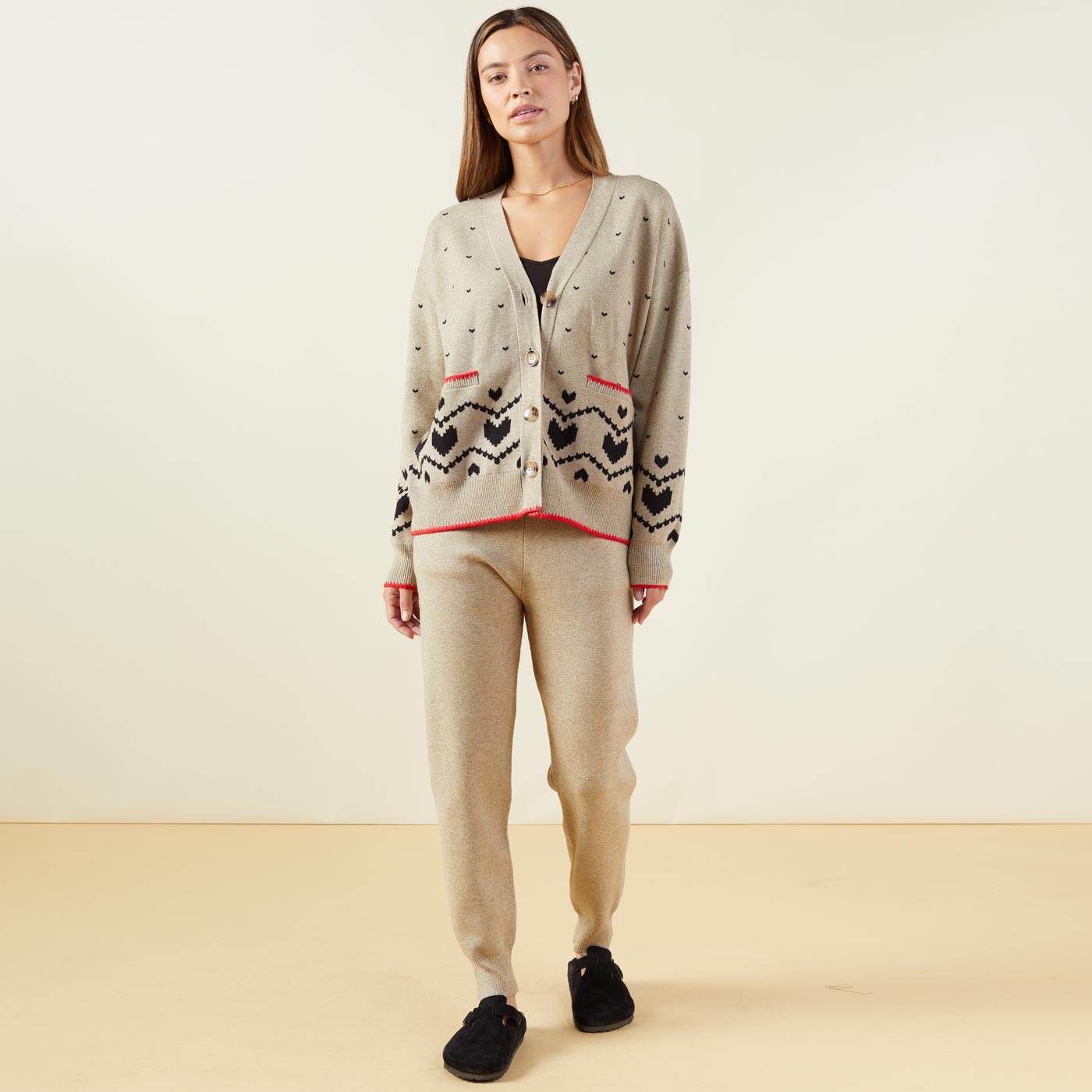 Front view of model wearing the supersoft sweater knit heart fair isle cardigan in oatmeal.