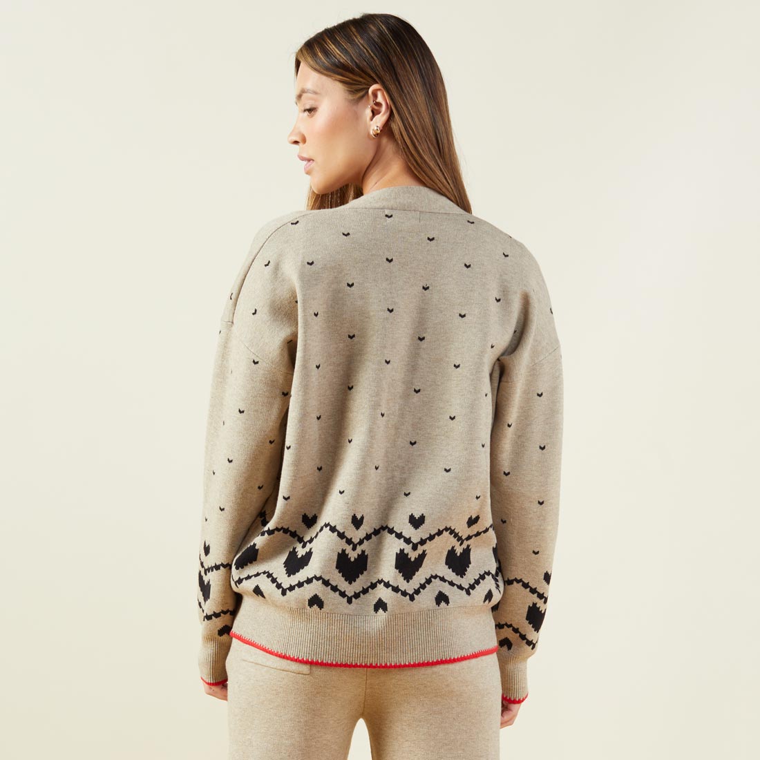 Back view of model wearing the supersoft sweater knit heart fair isle cardigan in oatmeal.
