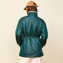Back view of model wearing the reversible sherpa lined jacket in deep forest.