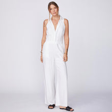 Front View of model wearing the Linen Halter Polo Jumpsuit in White