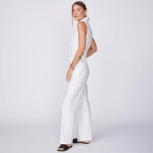 Side View of model wearing the Linen Halter Polo Jumpsuit in White