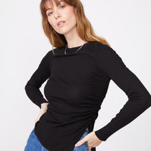 Front view of model wearing the needle rib slit long sleeve in black.