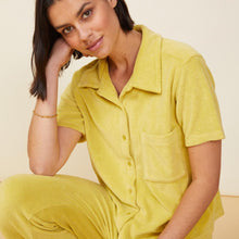 Front view of model wearing the terry cloth pocket shirt in kiwi.