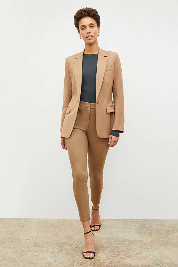 Front image of a woman standing wearing the Curie Pant—Everstretch in Saddle | Exclude