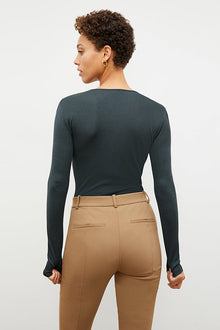 Back image of a woman standing wearing the Curie Pant—Everstretch in Saddle | Exclude | Grid Hover