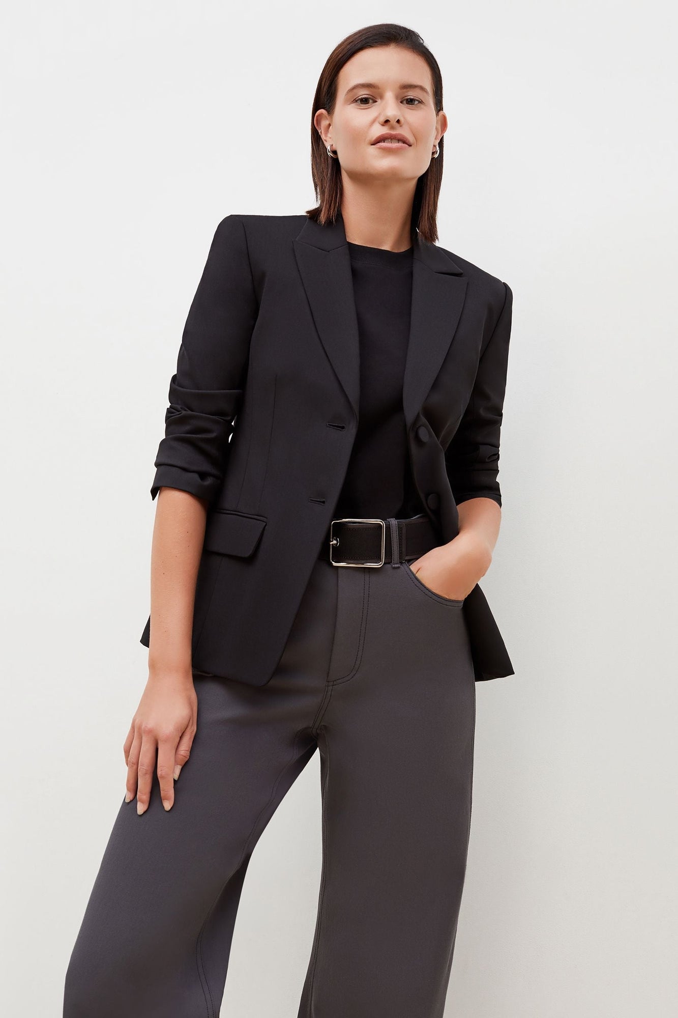 Front image of a woman standing wearing the bennett blazer wool twill in black | Grid | Exclude