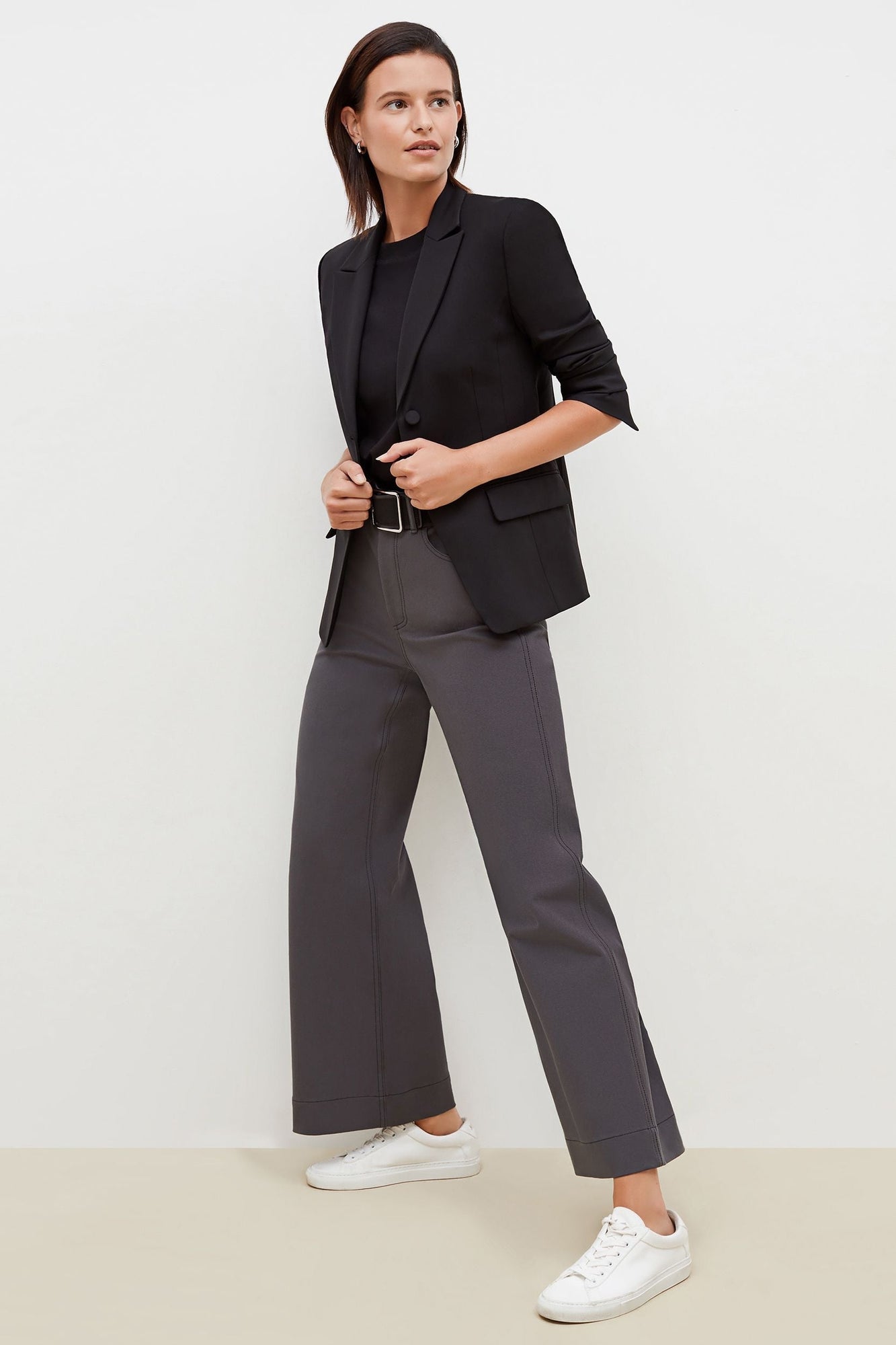 Side image of a woman standing wearing the bennett blazer wool twill in black | Grid Hover | Exclude
