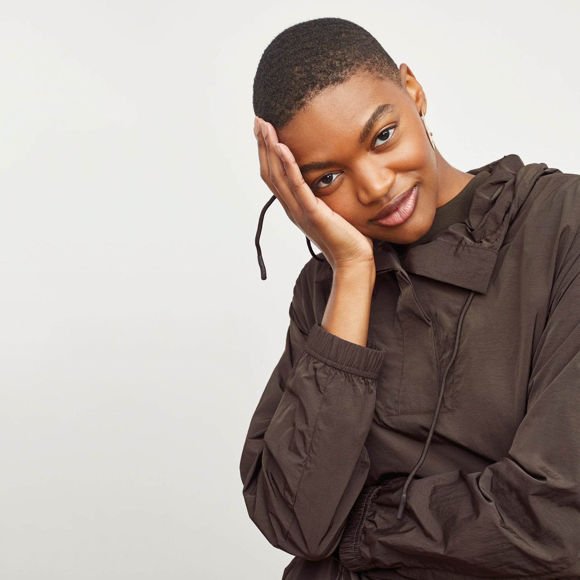 Front image of a woman standing wearing the Britt Hoodie—AirTech in Dark Moss | Exclude