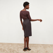 Back image of a woman standing wearing the Cobble Hill Skirt in Haze