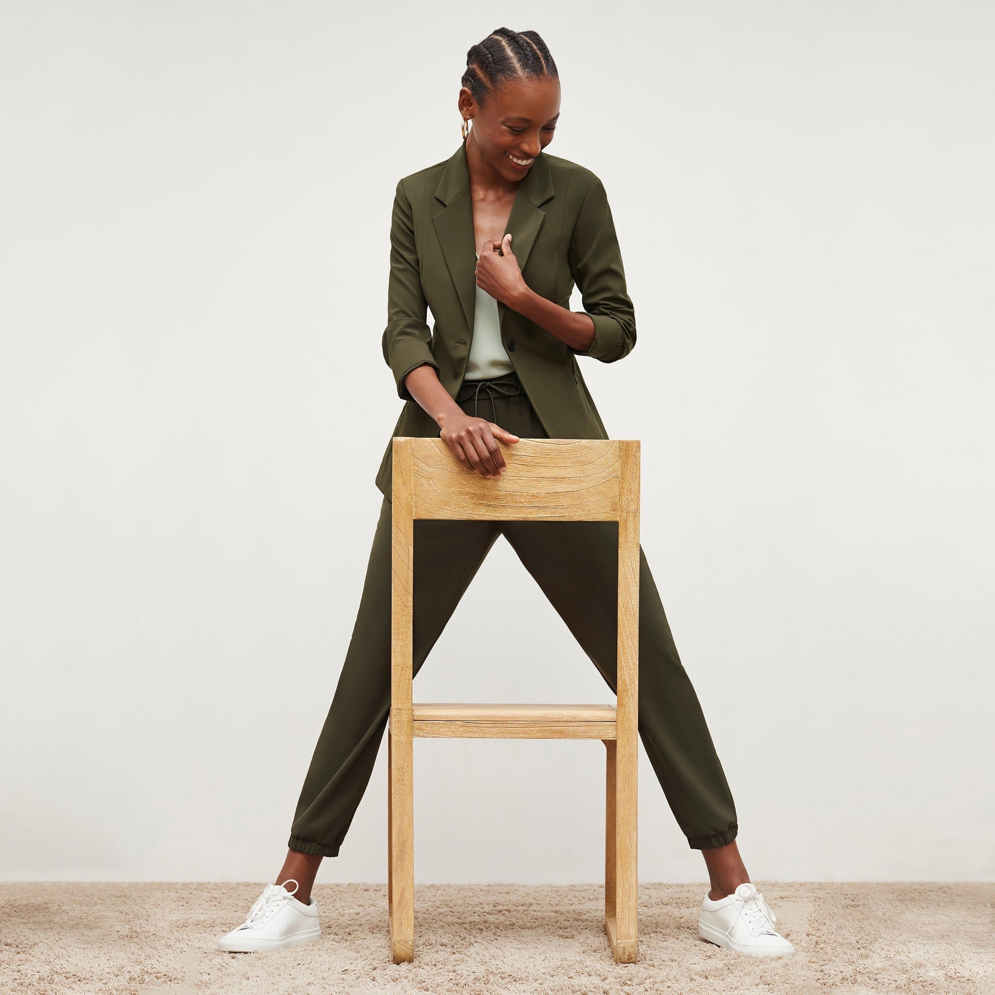Front image of a woman standing wearing the Delaney Jogger—OrigamiTech in Olive