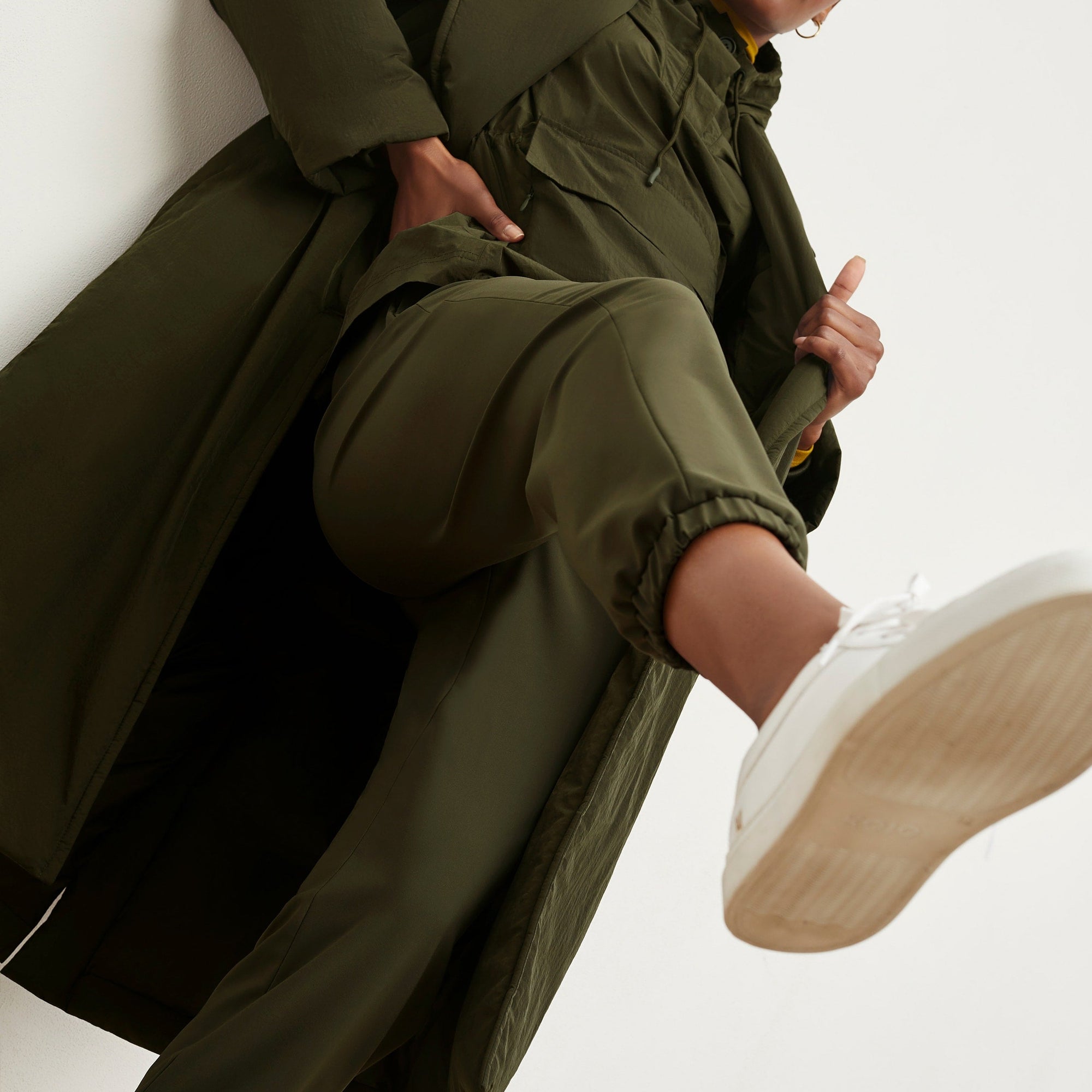 Detail image of a woman standing wearing the Delaney Jogger—OrigamiTech in Olive