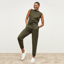 Front image of a woman standing wearing the Delaney Jogger—OrigamiTech in Olive | Exclude