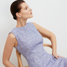 Detail image of a woman standing wearing the lindsay dress in cotton boucle in lapis / ivory
